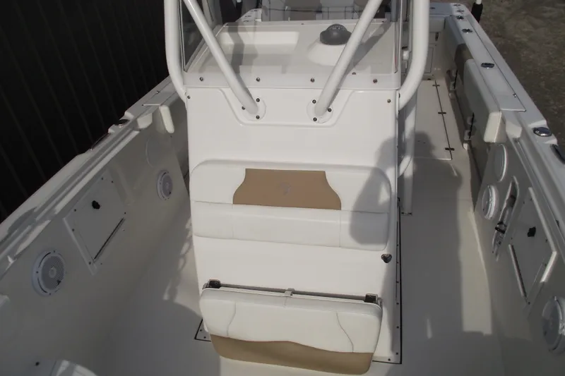 Slide: The Image of 2019 Edgewater 245CC boat interior with storage compartment and clean white finish. - 13