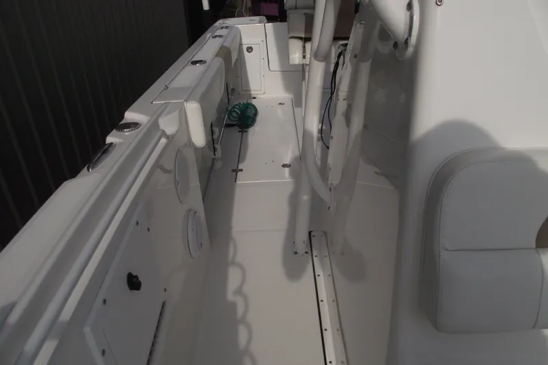 Slide: The Image of 2019 Edgewater 245CC boat interior with white seating and console. - 15