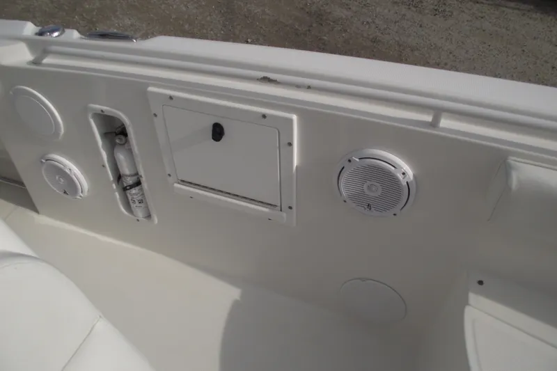 Slide: The Image of 2019 Edgewater 245CC boat interior with white seating and deck features. - 17