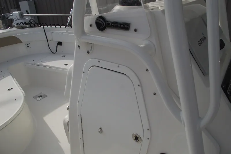 Slide: The Image of 2019 Edgewater 245CC boat interior with speakers and storage compartment. - 19