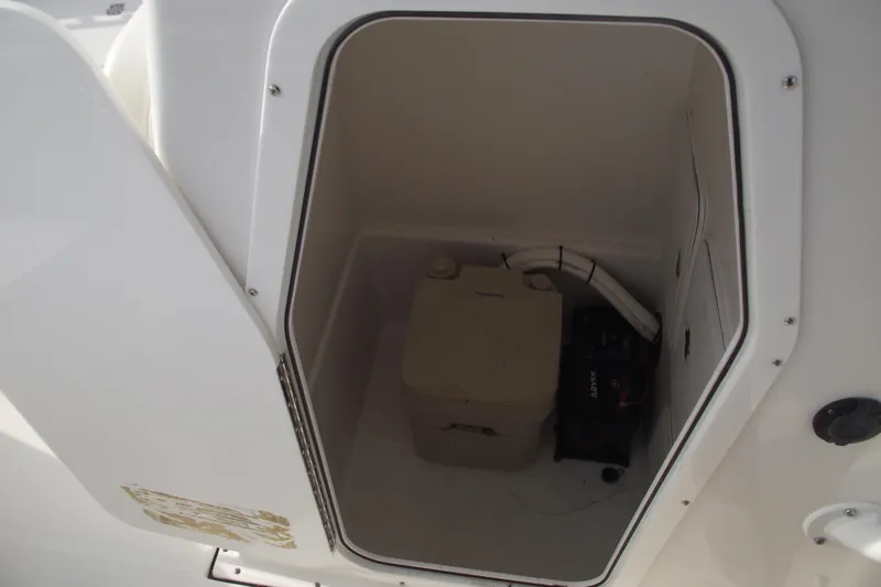 Slide: The Image of 2019 Edgewater 245CC boat interior with speakers and storage compartment. - 20