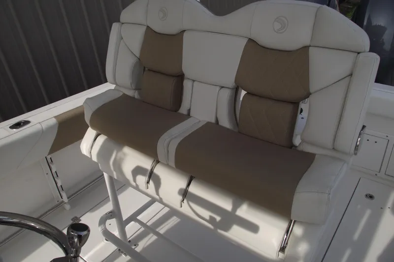 Slide: The Image of 2019 Edgewater 245CC boat interior with Garmin equipment and storage compartment. - 21