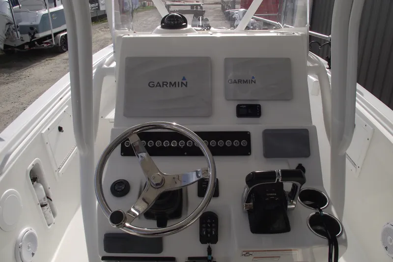 Slide: The Image of Storage compartment in 2019 Edgewater 245CC boat, featuring a portable toilet and battery. - 22