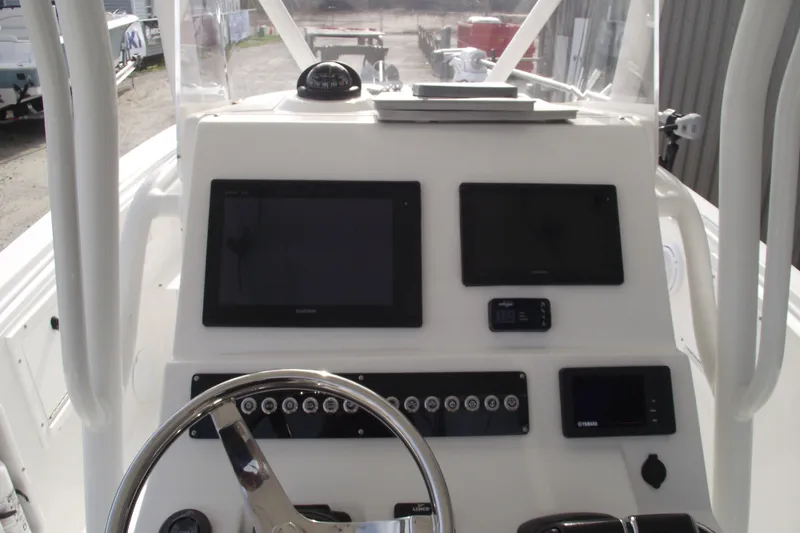 Slide: The Image of 2019 Edgewater 245CC boat seating with beige and white cushioned design. - 23