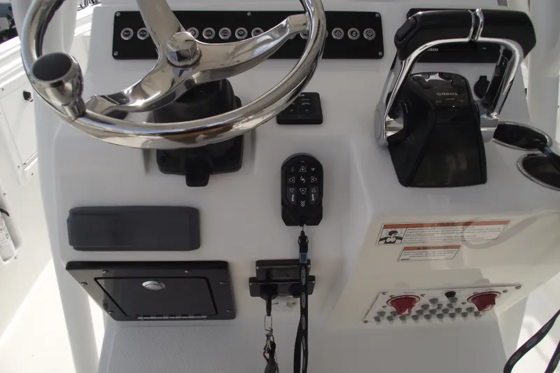 Slide: The Image of Edgewater 245CC 2019 boat console with Garmin navigation and steering wheel. - 24