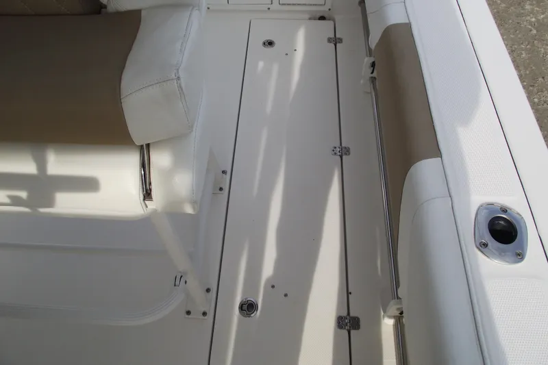 Slide: The Image of 2019 Edgewater 245CC boat console with rod holders and Garmin navigation system. - 28