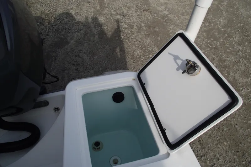 Slide: The Image of 2019 Edgewater 245CC boat interior with cushioned seating and storage compartments. - 35