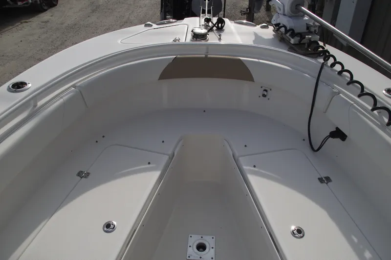 Slide: The Image of 2019 Edgewater 245CC boat interior with cushioned seating and clean white finish. - 8