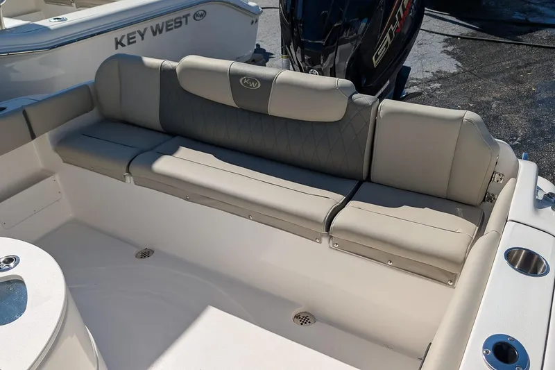Slide: The Image of 2026 Key West 239 FS boat interior with cushioned seating and motor. - 11