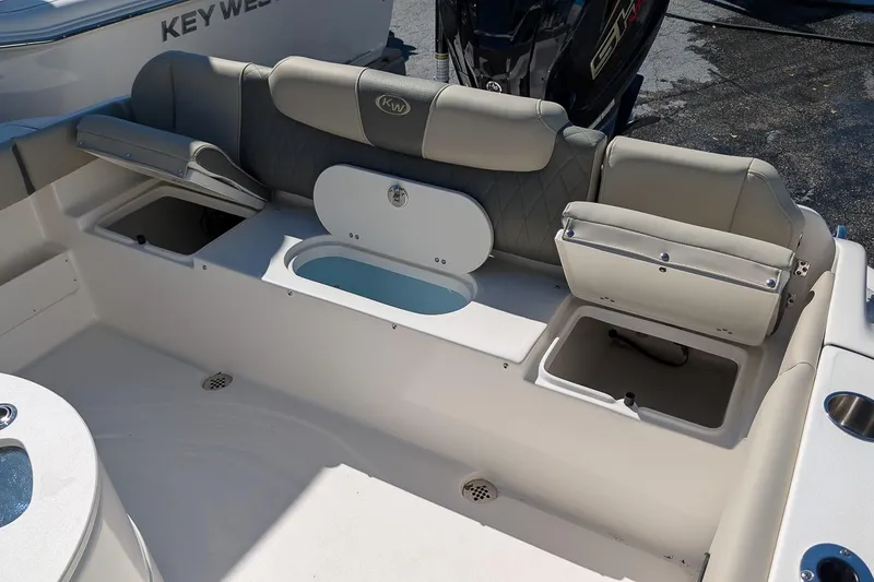 Slide: The Image of Interior view of a 2026 Key West 239 FS boat, featuring seating and storage compartments. - 12