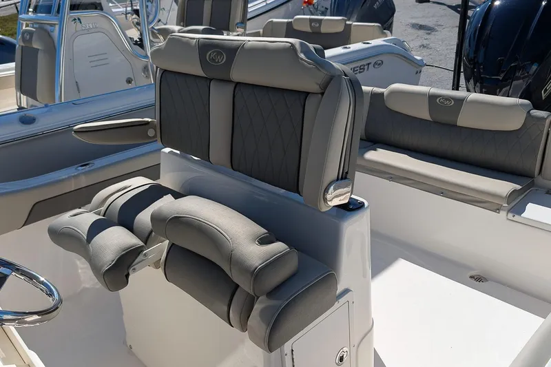 Slide: The Image of 2026 Key West 239 FS boat interior with cushioned seating and steering wheel. - 16