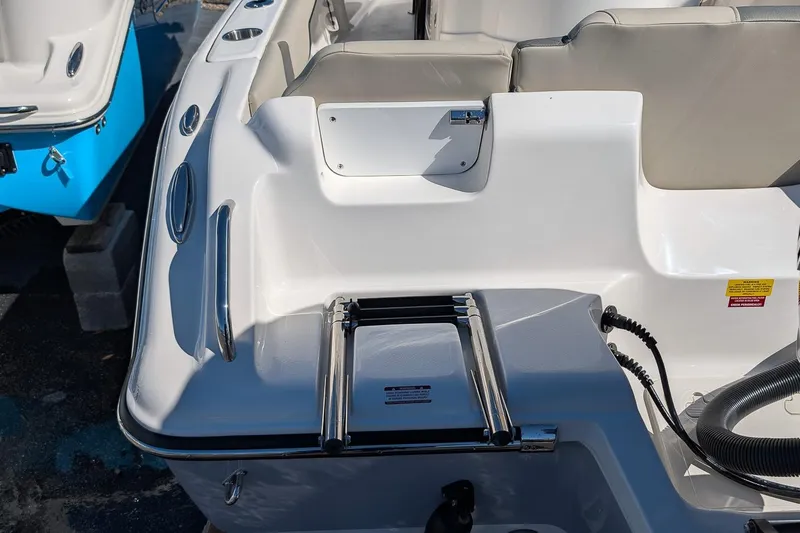 Slide: The Image of 2026 Key West 239 FS boat interior with seating and ladder detail. - 7