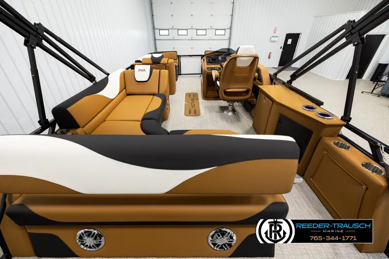 Slide: The Image of Luxurious interior of 2026 Avalon LSZ CRB pontoon boat with tan and black seating. - 16