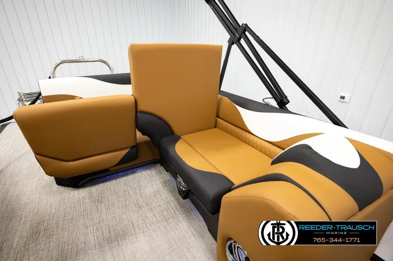 Slide: The Image of 2026 Avalon LSZ CRB boat interior with tan and black seating, Reeder-Trausch Marine logo. - 24