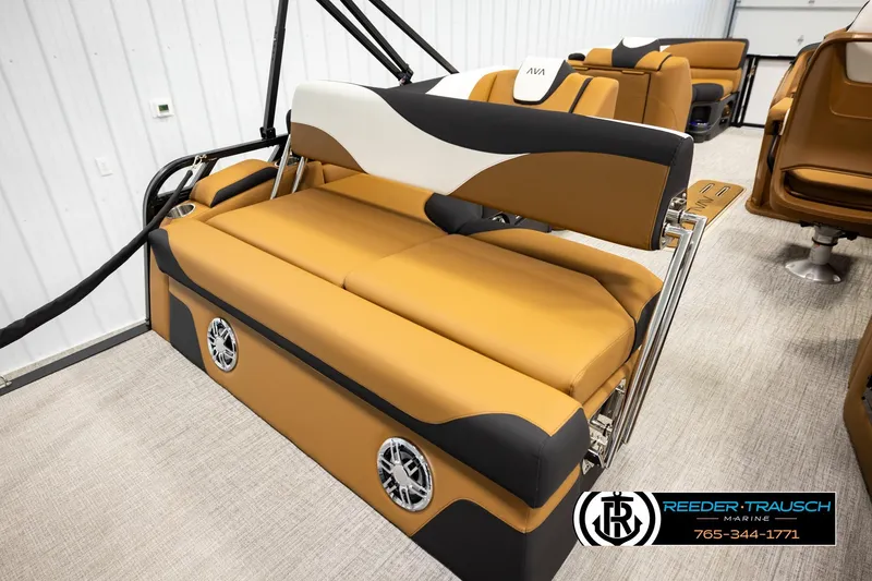 Slide: The Image of 2026 Avalon LSZ CRB boat interior with tan and black seating, featuring built-in speakers. - 26