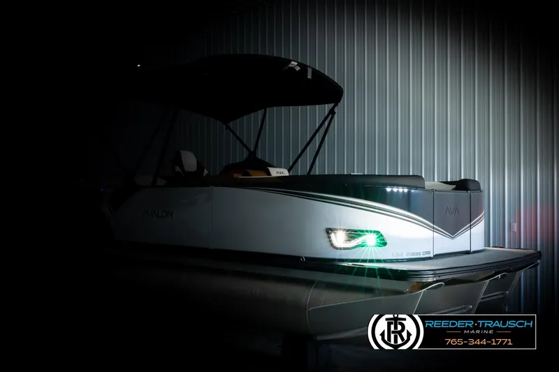 Slide: The Image of 2026 Avalon LSZ CRB pontoon boat with illuminated headlight in a dimly lit setting. - 4