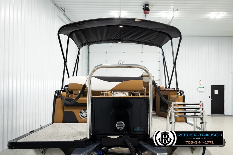Slide: The Image of 2026 Avalon LSZ CRB pontoon boat in a showroom with canopy and ladder. - 7
