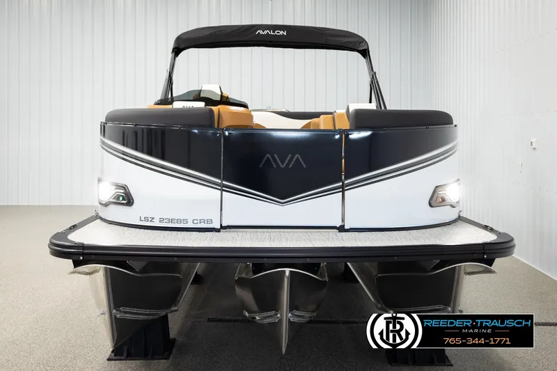 Slide: The Image of 2026 Avalon LSZ CRB pontoon boat in showroom, front view with sleek design. - 8