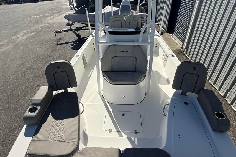 Slide: The Image of 2022 Sea Pro 248 Bay boat interior with gray seating and cup holders. - 11