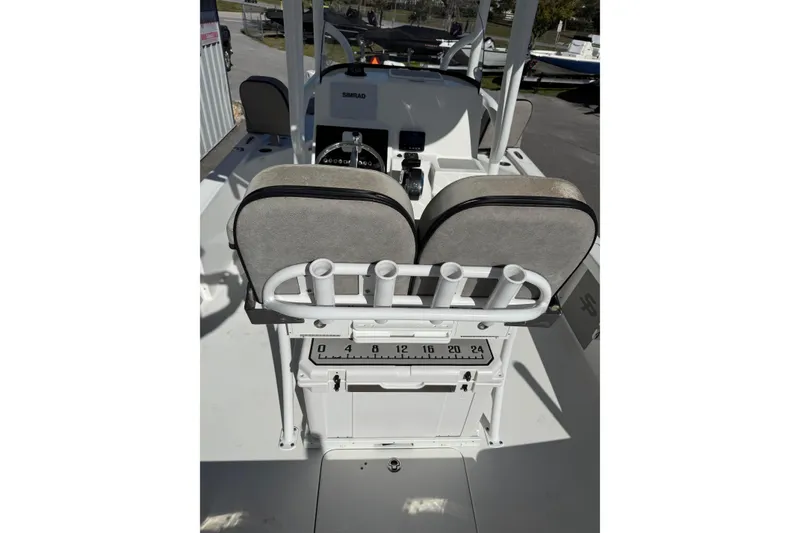 Slide: The Image of 2022 Sea Pro 248 Bay boat interior with seating and rod holders. - 13