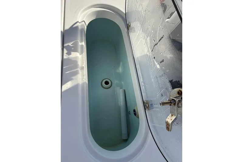 Slide: The Image of Livewell on 2022 Sea Pro 248 Bay boat, featuring a clear lid and secure latch. - 9