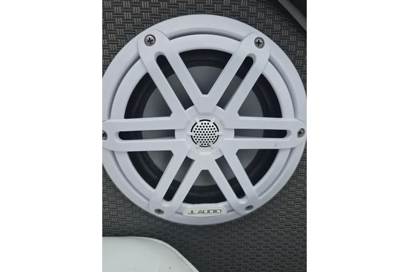 Slide: The Image of White JL Audio speaker on 2021 Monterey 255SS Super Sport boat interior. - 10