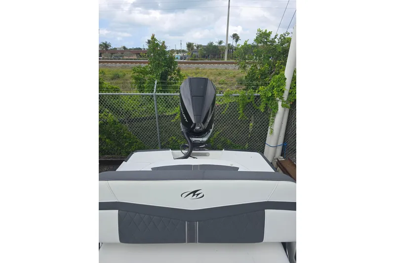 Slide: The Image of 2021 Monterey 255SS Super Sport boat with outboard motor, parked near a fence. - 11