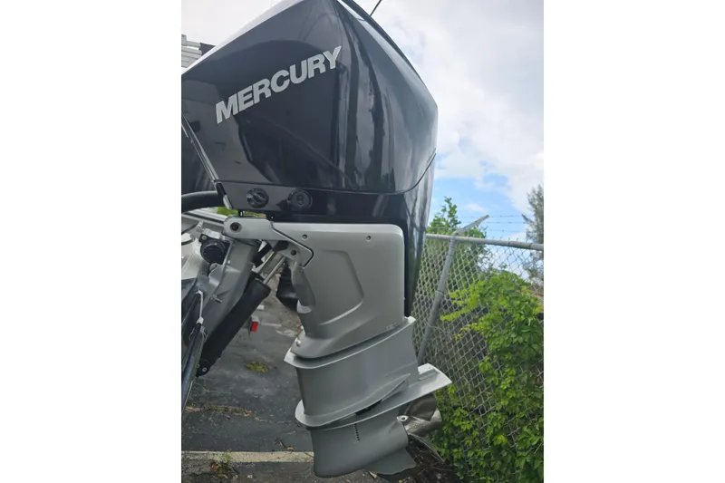 Slide: The Image of Mercury outboard motor on a 2021 Monterey 255SS Super Sport boat, parked near a fence. - 13