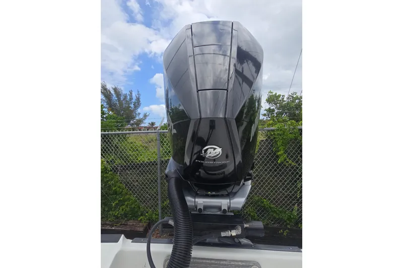 Slide: The Image of Black outboard motor on a 2021 Monterey 255SS Super Sport boat, against a cloudy sky. - 4