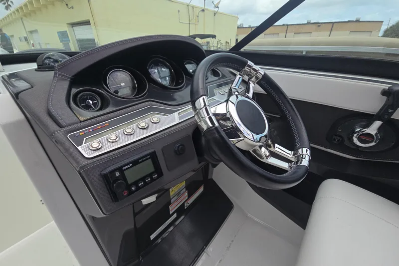 Slide: The Image of Steering console of 2021 Monterey 255SS Super Sport boat with modern controls and gauges. - 6