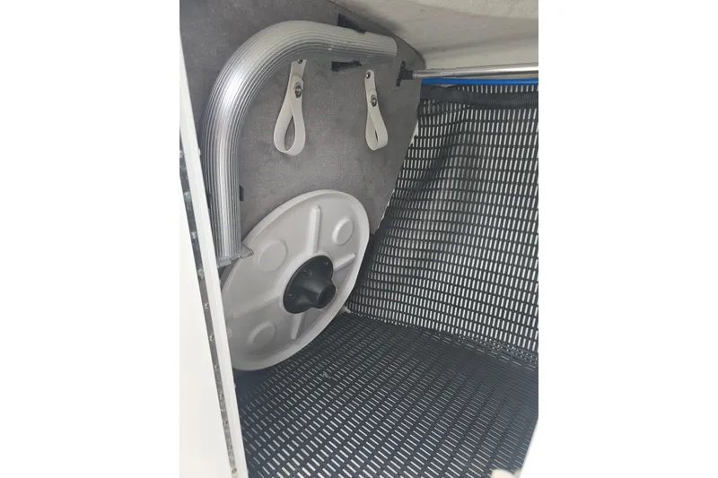 Slide: The Image of Storage compartment of 2021 Monterey 255SS Super Sport boat with hose and cover. - 8