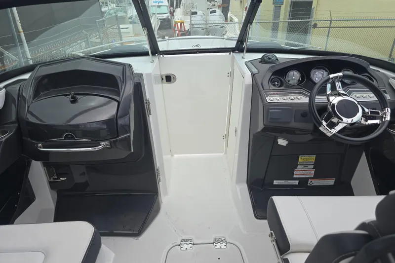 Slide: The Image of Interior view of 2021 Monterey 255SS Super Sport boat cockpit with steering wheel and controls. - 9