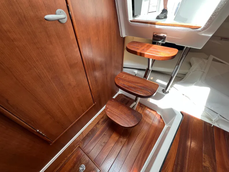 Slide: The Image of Interior of 2025 Pursuit OS 325 Offshore with wooden steps and flooring. - 20