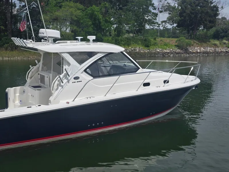 Slide: The Image of 2025 Pursuit OS 325 Offshore boat on calm water, featuring sleek design and modern amenities. - 4