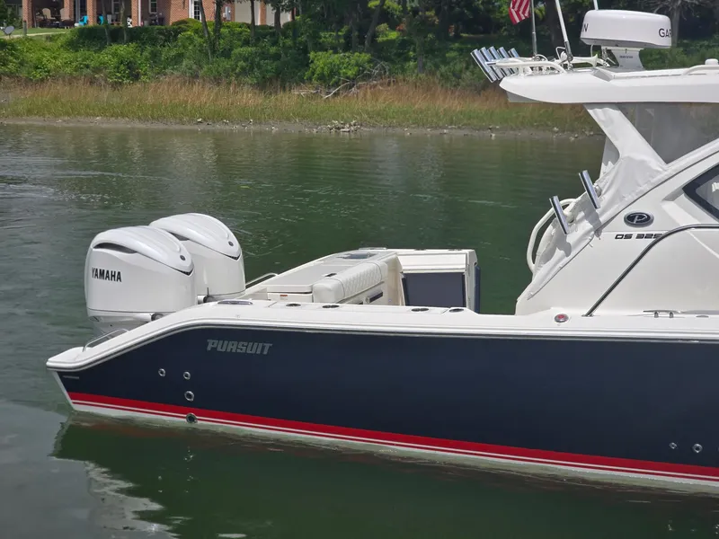 Slide: The Image of 2025 Pursuit OS 325 Offshore boat with Yamaha engines on calm water. - 6