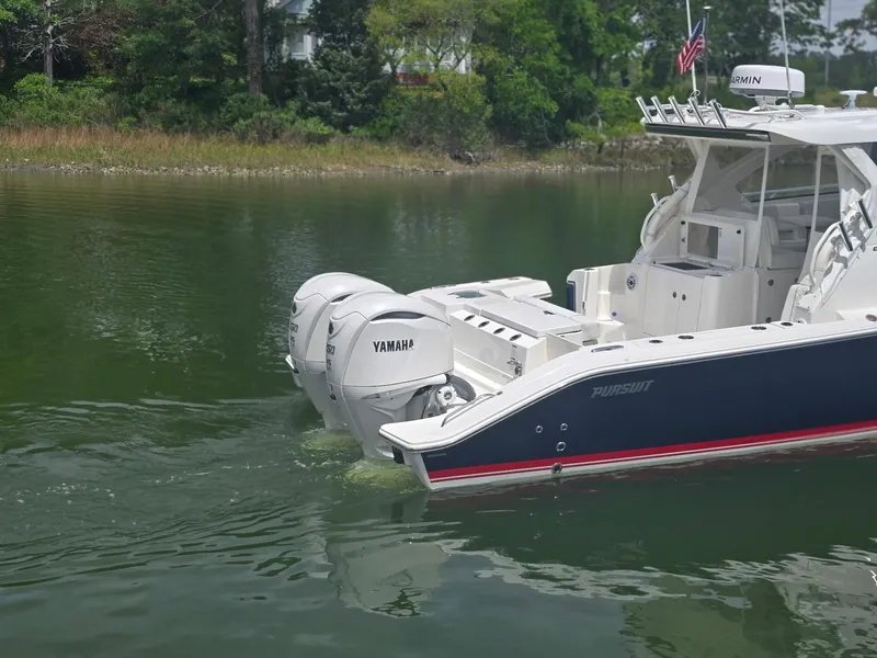 Slide: The Image of 2025 Pursuit OS 325 Offshore boat with Yamaha engines on calm water. - 7