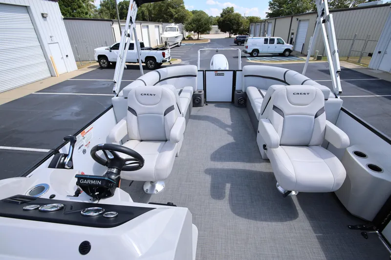 Slide: The Image of 2023 Crest Classic LX 220 SLC pontoon boat interior with plush seating and Garmin navigation. - 10