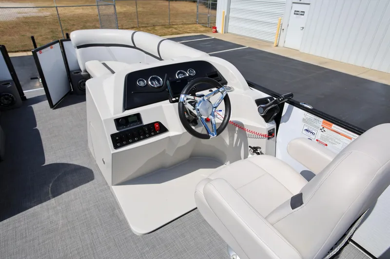 Slide: The Image of 2023 Crest Classic LX 220 SLC boat interior with steering console and seating. - 13
