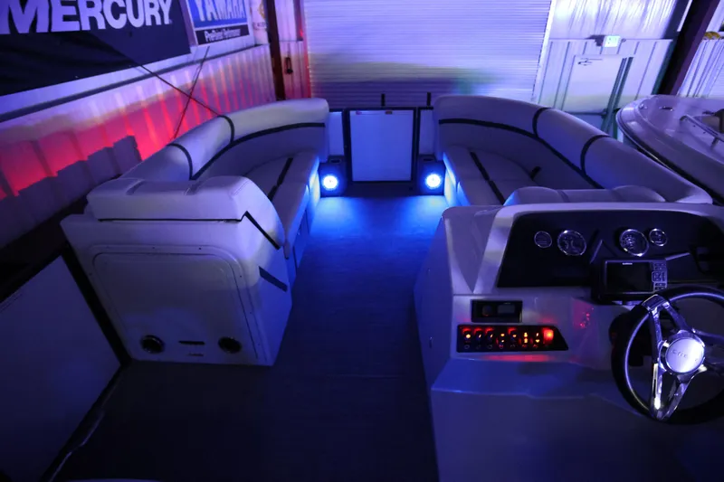 Slide: The Image of 2023 Crest Classic LX 220 SLC boat interior with ambient blue lighting and modern dashboard. - 21