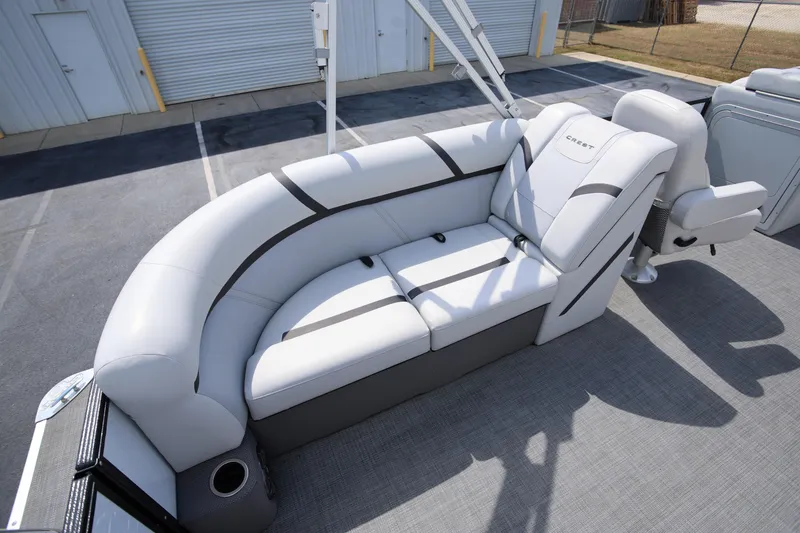 Slide: The Image of 2023 Crest Classic LX 220 SLC pontoon boat with sleek white seating and modern design. - 9