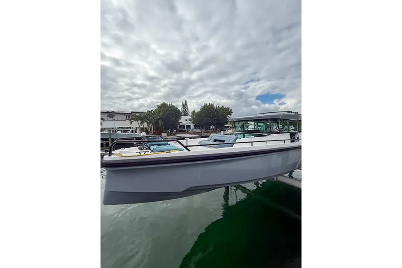 The Image of 2023 Axopar 37 XC Cross Cabin boat docked under cloudy sky. - 0
