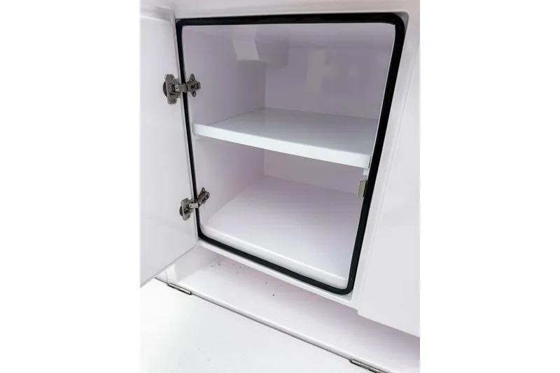 Slide: The Image of Open storage compartment in 2023 Axopar 37 XC Cross Cabin boat. - 11