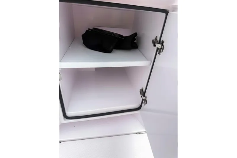 Slide: The Image of Open storage compartment in 2023 Axopar 37 XC Cross Cabin boat. - 12