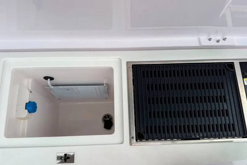 Slide: The Image of 2023 Axopar 37 XC Cross Cabin interior storage and grill area. - 14