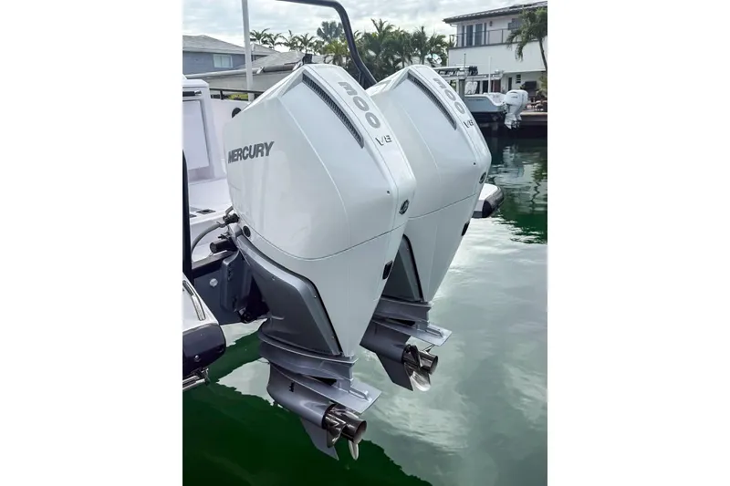 Slide: The Image of Twin Mercury outboard engines on a 2023 Axopar 37 XC Cross Cabin boat. - 2