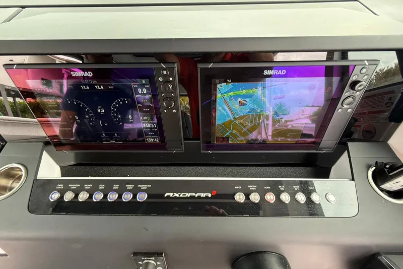 Slide: The Image of Control panel of 2023 Axopar 37 XC Cross Cabin with dual Simrad displays. - 29