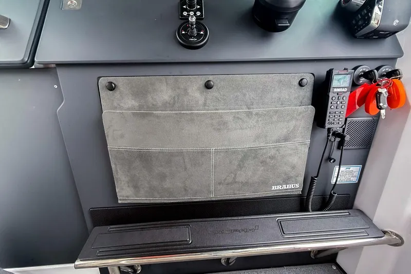 Slide: The Image of 2023 Axopar 37 XC Cross Cabin dashboard with Brabus detailing and communication equipment. - 32