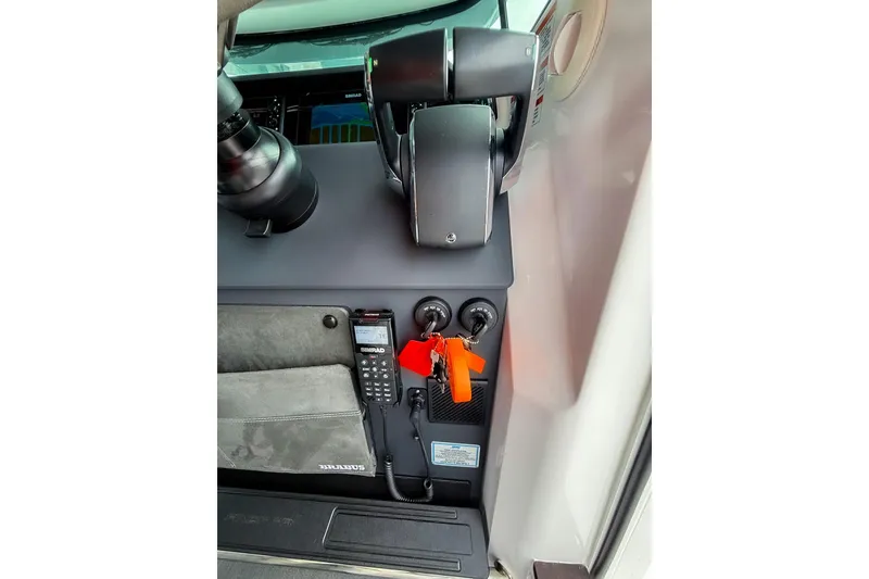 Slide: The Image of Control panel of 2023 Axopar 37 XC Cross Cabin with navigation equipment and keys. - 33