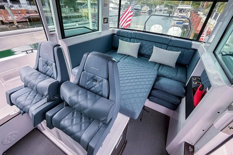 Slide: The Image of 2023 Axopar 37 XC Cross Cabin interior with luxurious seating and convertible lounge area. - 36
