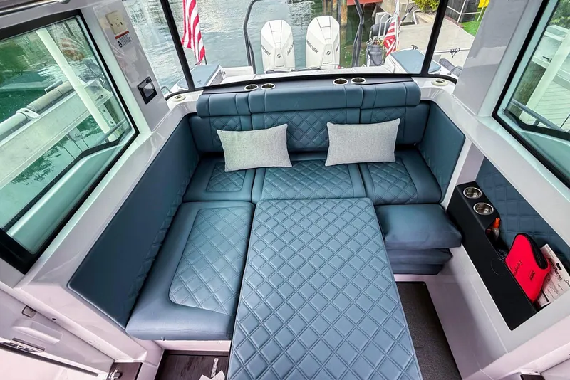 Slide: The Image of Luxurious interior of 2023 Axopar 37 XC Cross Cabin with quilted seating and cushions. - 38